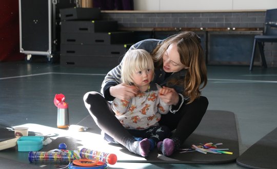 Young boy and mum playing together.