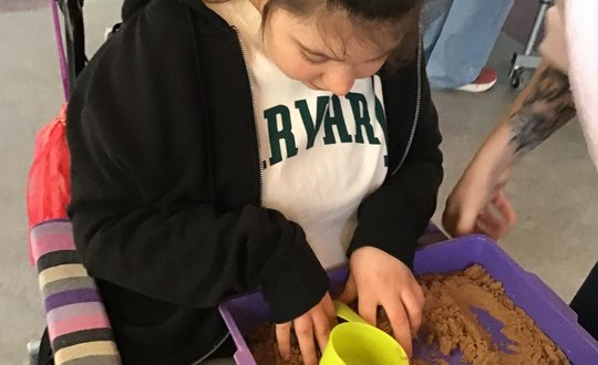 Girl playing with sand.