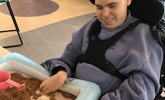 Boy playing with sand.