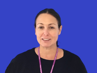 Woman smiling against a blue background
