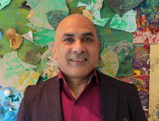 Man smiling against artistic background