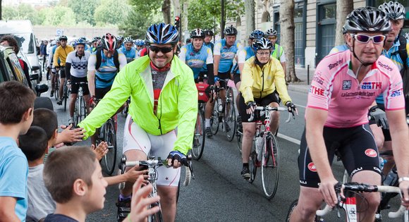 Cyclists passing supporters in France