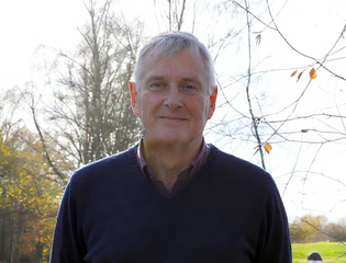 Man in front of trees