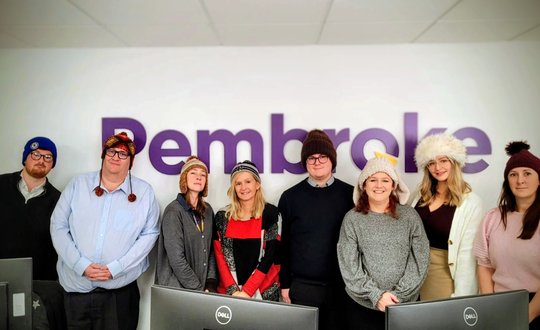 Group of adults wearing woolly hats 