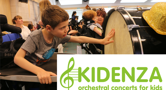 Young boy reaching out to touch drum