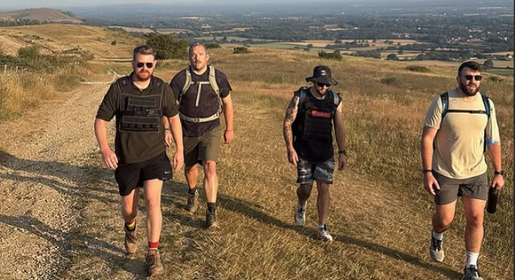 4 men smiling walking up the downs.