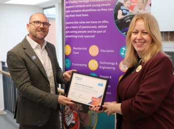 A man and woman holding an award