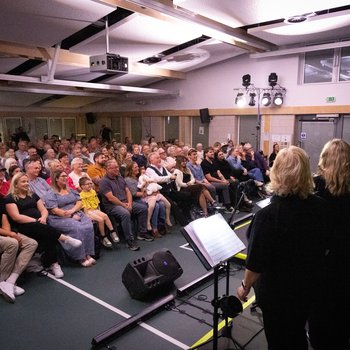 Audience facing the stage.