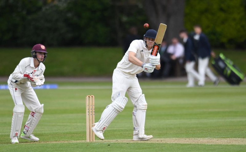 Man playing cricket.