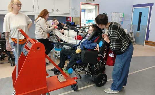 Young person playing with a catapult.