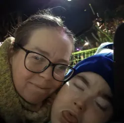 Women and young person taking a selfie together.