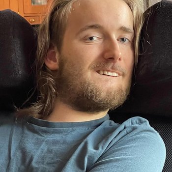 Boy smiling with a blue top.