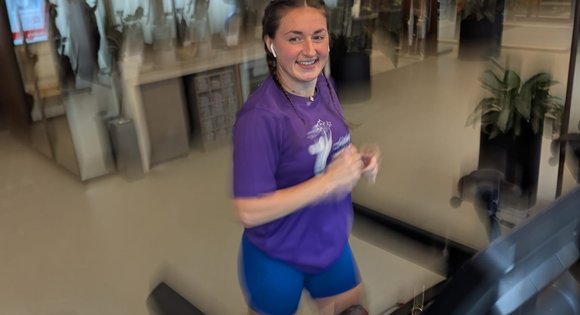 Girl running on a treadmill.