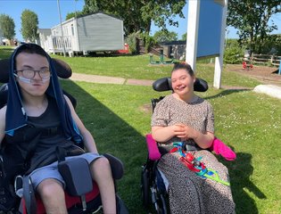 Boy and girl outside smiling.