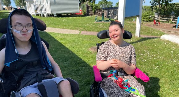 Boy and girl outside smiling.