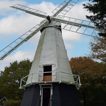 White windmill with blue skys in the background
