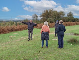 Man pointing to view while on a walk in the countryside