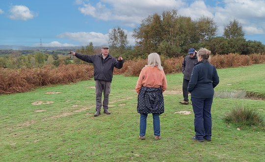 Man pointing to view while on a walk in the countryside