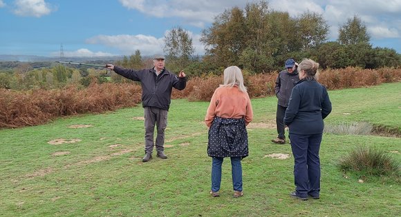 Man pointing to view while on a walk in the countryside